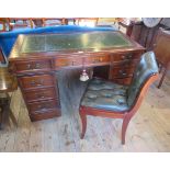 A reproduction mahogany veneered twin pedestal desk with green hide inset top,