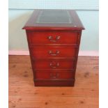 A mahogany veneered two drawer filing cabinet with green simulated tooled hide inset top,