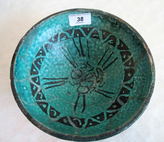 A Persian turquoise glazed fritware bowl, decorated with a running black band.