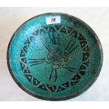 A Persian turquoise glazed fritware bowl, decorated with a running black band.