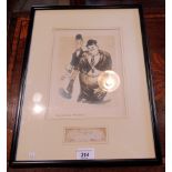 An ebonised framed and glazed reproduction print of Stan Laurel and Oliver Hardy,