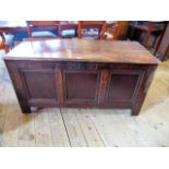 An 18th century oak coffer, the rising planked top enclosing a candle box fitted interior,