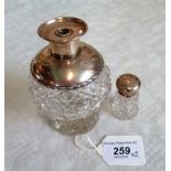 A silver mounted and cut glass atomizer base and a silver mounted and cut glass pepperette.
