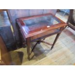 A reproduction mahogany bijouterie cabinet, the rising lid with glass top and sides,