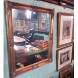 A gilt composite wall mirror, the scallop decorated frame enclosing a plain rectangular plate.