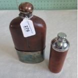 A leather mounted hip flask with mushroom cap, together with another of cylindrical form.