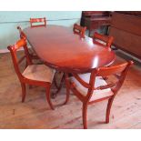 A reproduction yew wood veneered D-end extending dining table,