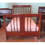 An Edwardian mahogany and satinwood strung double bed frame with slatted head and tail boards.