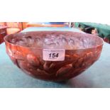 A Newlyn beaten copper metalware fruit bowl, with a running band of raised flowers.