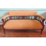 An Edwardian mahogany framed and pale gold velour upholstered three seat salon settee,