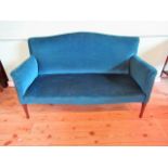 An Edwardian two person salon settee, later upholstered in deep turquoise velour,