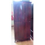 An Edwardian mahogany lady's wardrobe of bow front form,