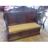 A Victorian oak settle, the scallop carved rail over a three panel back with pierced supports,