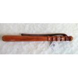 A turned wood truncheon with leather leash.