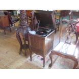 An early 20th century Columbia gramophone, contained within a floor standing oak cabinet,