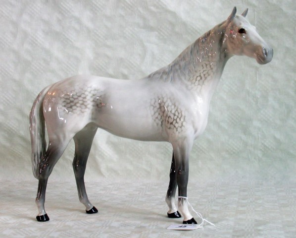 A large Beswick model of a dappled grey stallion.