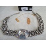 A large Egyptian-style pendant and a South American Inca-type pendant and a large stone set chain