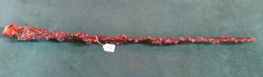 A 19th century carved Blackthorn walking stick with primitive carved head pommel.