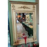 A Regency-style pier glass, the cream painted wooden frame with applied floral mouldings,