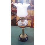 A late Victorian gilt brass and glass table oil lamp with duplex burner, frosted and frilled shade.