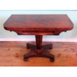 A William IV mahogany card table, the rectangular swivel fold-over top on an octagonal column,