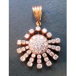 A diamond set gold sunburst pendant. Condition Report: Marked 13c.