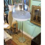 A contemporary chrome standard lamp with pierced domed shade.
