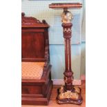 An early 19th century-style mahogany and giltwood mounted torchere,