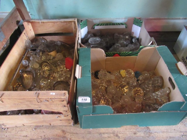 Three boxes containing a collection of several dozen cut and moulded decanter stoppers, various.