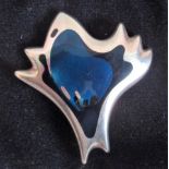 A cased Georg Jensen design silver and enamel fluid brooch in the form of a stylized bird in flight.