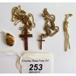 A 9ct gold cross and chain, together with a yellow metal cross & chain and a locket & chain.