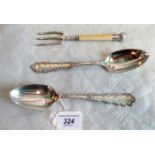 A pair of early 20th century American sterling silver serving spoons, with cast scrolling edges,