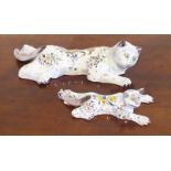 A pair of French faience wall pockets, each florally decorated and modelled as a recumbent cat.