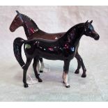 A Beswick model of a bay horse, with head turned to right, together with another,