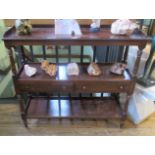 A reproduction three tier buffet with two central drawers on turned and block supports.