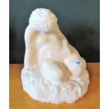 A mid-20th century carved veined ochre marble seated figure 'Motherhood'.