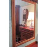 A contemporary pine framed wall mirror with rectangular bevelled plate.