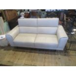 A cream hide upholstered contemporary two person settee with adjustable head supports on a chrome