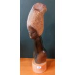 A contemporary Zimbabwian springstone bust study of an African-esque lady on a light wood socle.