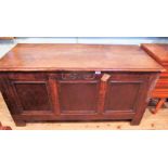 An 18th century oak coffer, the rising plank top enclosing a candle box fitted interior,