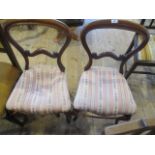 A pair of Victorian mahogany spoon back dining chairs, each having scrolled splat,