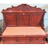 A Victorian oak settle, the scallop carved rail over a three panel back with pierced supports,
