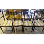 A set of four Edwardian mahogany dining chairs, each having incised carved rail, vertical splats,
