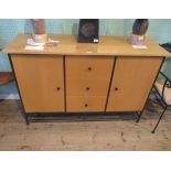 A contemporary cast metal and beech veneered sideboard,