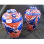 A pair of circa 1930's Chameleon Ware vases of cylindrical tapering form,