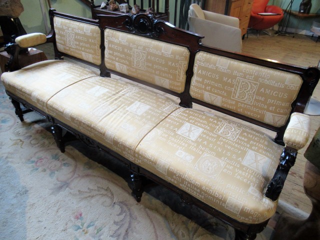 An early 19th century-style three person parlour settee,