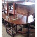 An oak drop leaf gateleg dining table with twin demi lune flaps,on bobbin turned and block supports,