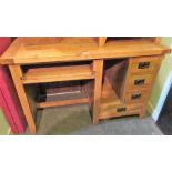 A contemporary light oak desk with rectangular top,