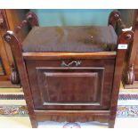 An Edwardian mahogany piano stool with panelled fall, enclosing provision for sheet music.