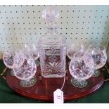 A cut glass spirit decanter and six glasses, on a brass mounted mahogany serving tray.